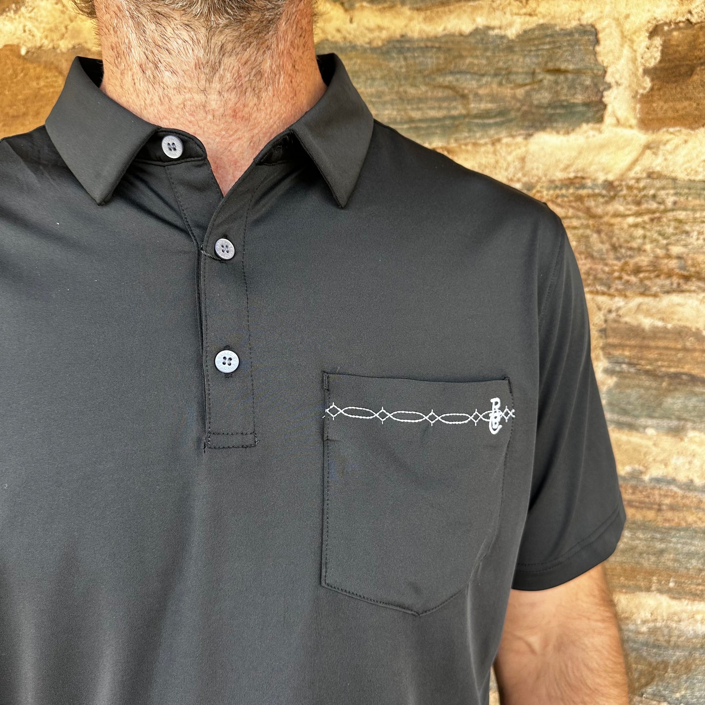 Raised by Coyotes | Bootstitch Pocket Polo | Black