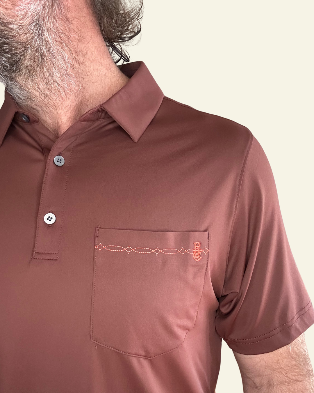 Raised by Coyotes | Bootstitch Pocket Polo| Texas Maroon