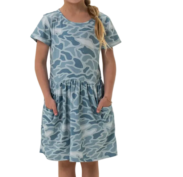 Girl wearing a blue camouflage dress on a white background
