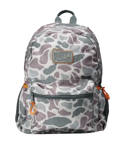A backpack featuring a gray, white, and muted purple camouflage pattern, with a brown leather patch on the front pocket and orange zipper pulls, shown against a plain white background.