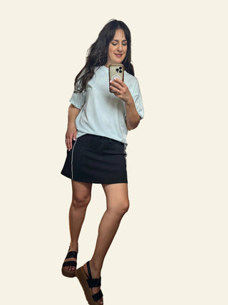 Woman taking a mirror selfie in a store 