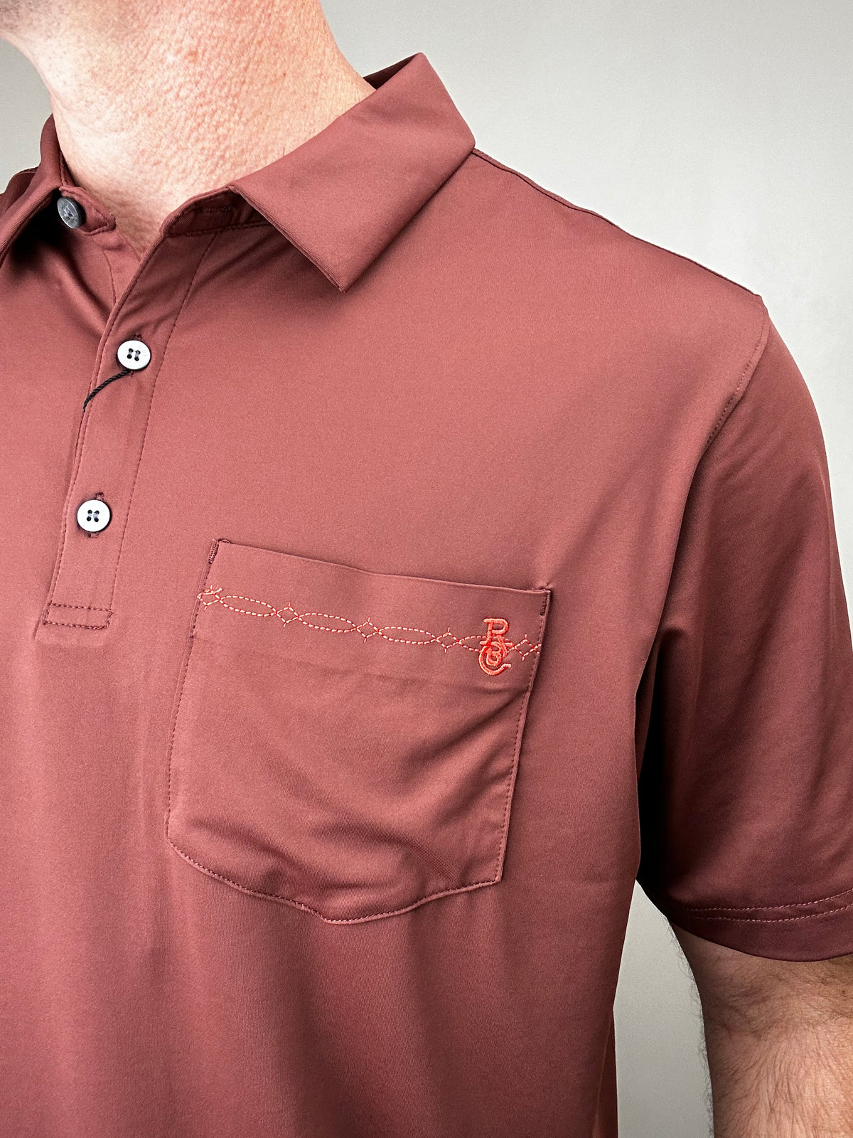 Raised by Coyotes | Bootstitch Pocket Polo| Texas Maroon