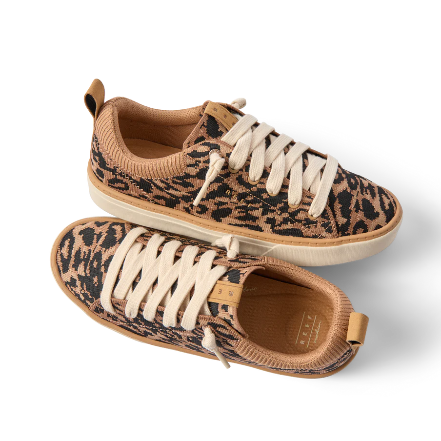 Pair of leopard print sneakers with beige accents on a white background