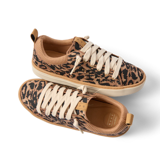 Pair of leopard print sneakers with beige accents on a white background