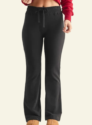 Black pants worn by a person on a gray background