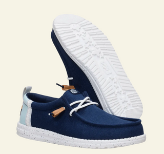 Navy blue casual shoe with white sole on a white background