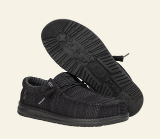 Black casual shoes with textured sole on a white background