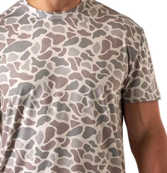 Person wearing a camouflage-patterned t-shirt on a white background