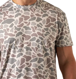 Person wearing a camouflage-patterned t-shirt on a white background