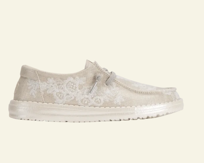 Beige casual shoe with floral pattern on a white background