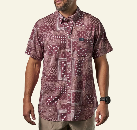 Man wearing a patterned shirt on a white background