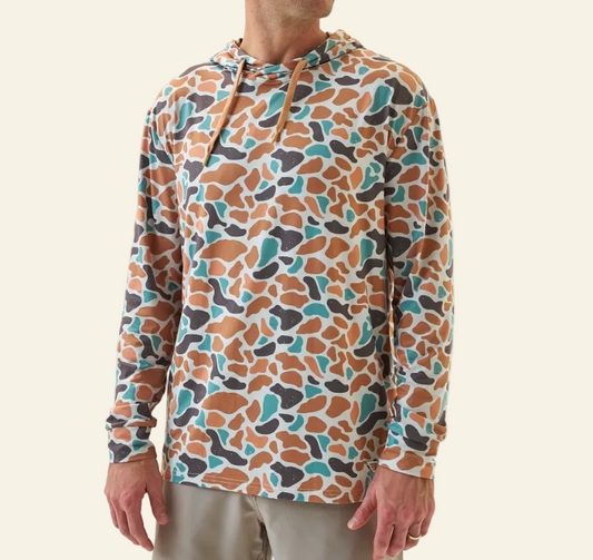 Person wearing a colorful patterned hoodie on a white background