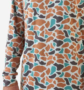 Close-up of a long-sleeve shirt with a colorful abstract pattern on a white background