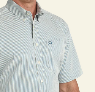 Man wearing a light blue striped shirt with a logo on a white background