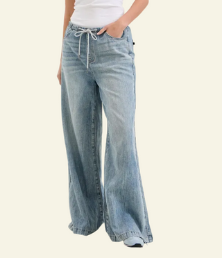 Light blue wide-leg jeans worn by a person on a white background