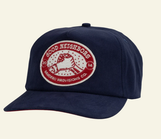 Navy blue cap with a red and white logo on a beige background