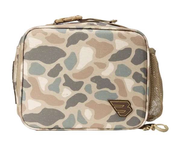 A rectangular soft-sided bag with a desert camouflage pattern in beige, brown, gray, and off-white. It features a top zipper closure, a side mesh pocket, and a small metallic shield logo on the front.