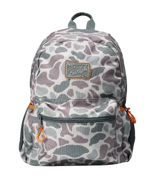 A backpack featuring a gray, white, and muted purple camouflage pattern, with a brown leather patch on the front pocket and orange zipper pulls, shown against a plain white background.